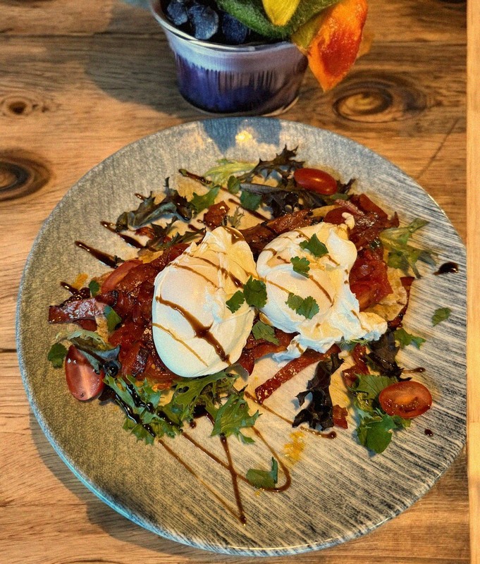 Eggs Benedict with crispy bacon, poached eggs and balsamic glaze on artisan toast at Mamma J's